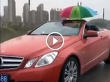 Bizarre Video Shows Man Holding Umbrella Driving A Convertible In The Rain