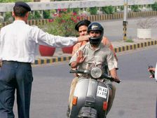 Riding Without Helmet — Woman Kicks Cop