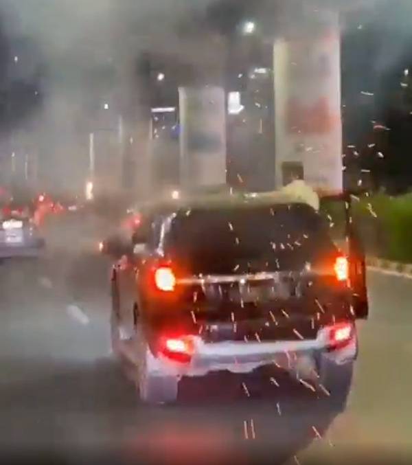 Persons Bursting Crackers From Their Car Persons Bursting Crackers From Their Car