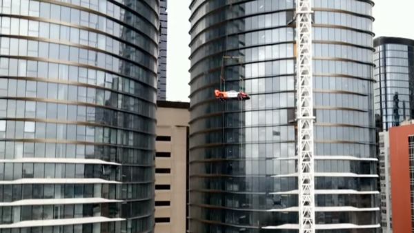 McLaren Senna GTR lifted to 57tj floor apartment