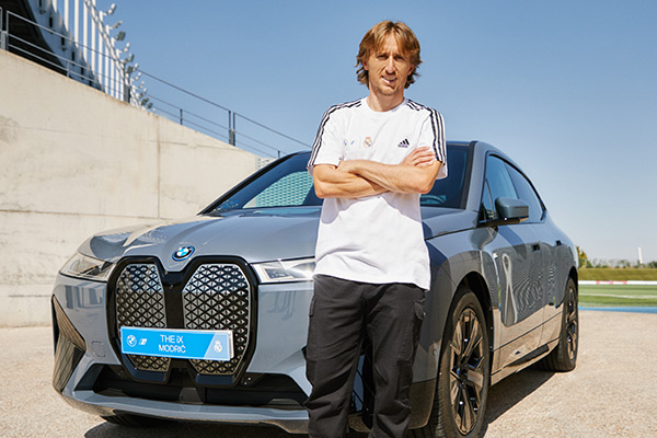 Luka Modric in front of the BMW iX