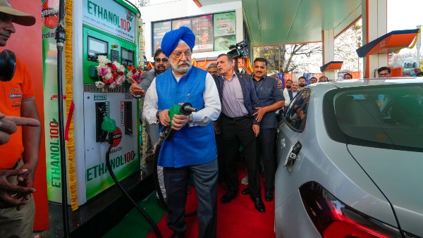 Union Minister of Petroleum and Natural Gas Hardeep Singh Puri fills a car with E100