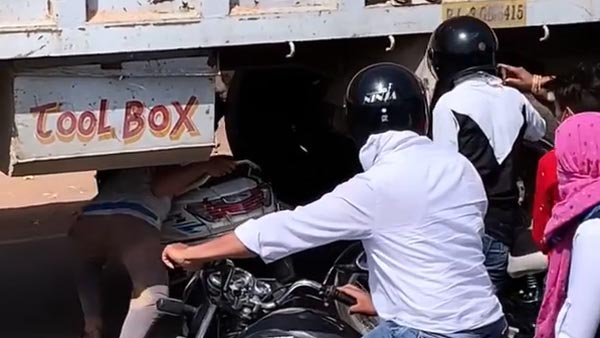 young-man-takes-scooter-under-truck-video-goes-viral-details