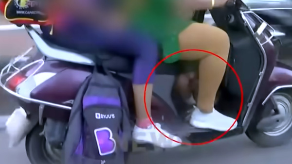 Mother hides child on scooter to escape AI cameras