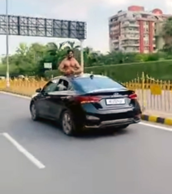 half-naked-man-out-of-moving-sunroof