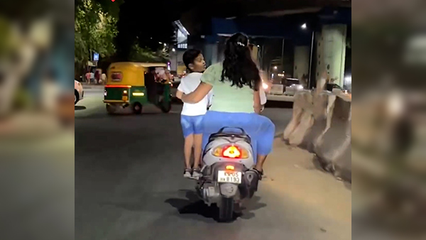 Bengaluru Child Standing On The Footrest Of A Moving Scooter Netizens Anger Against The Couple