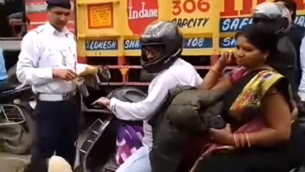 ദേ ഇത്രയേയുള്ളൂ സുരക്ഷ, സ്‌കൂട്ടര്‍ യാത്രികയുടെ ഹെല്‍മറ്റ് എറിഞ്ഞുടച്ച് പൊലീസ് — വീഡിയോ