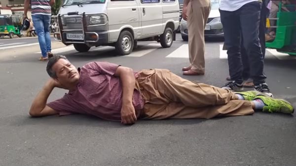 മകന് ലഭിച്ച പിഴയ്ക്കെതിരെ റോഡിൽ കിടന്ന് അച്ഛന്റെ പ്രതിഷേധം; വീഡിയോ വൈറൽ