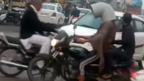 man wears water pipe to avoid challan