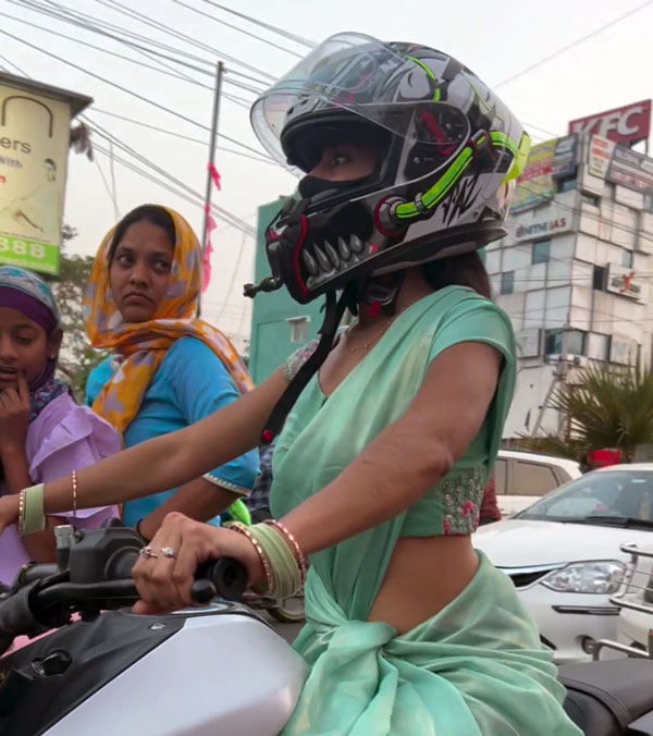woman riding bike in saree