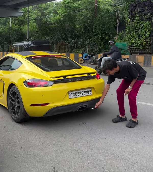 man with porsche plays with fire