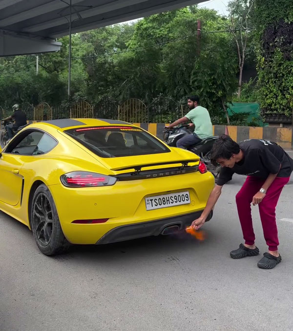 man with porsche plays with fire
