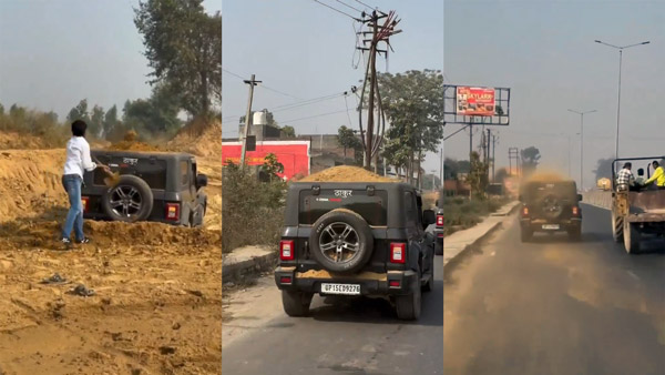 man drives thar with pile of sand on top