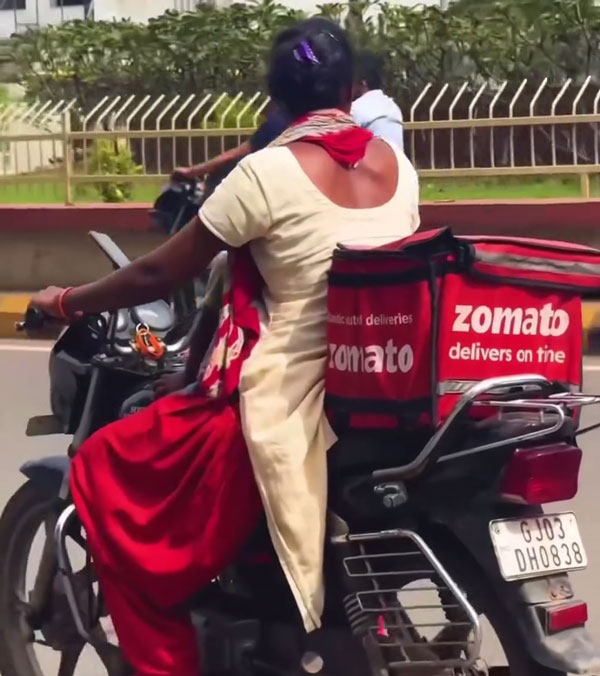 zomato delivery agent rides bike with her child