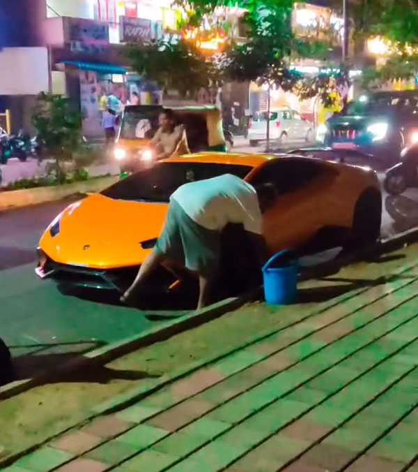 man cleaning lamborghini huracan bucket water