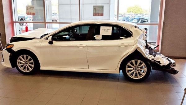 crashed camry displayed in toyota showroom