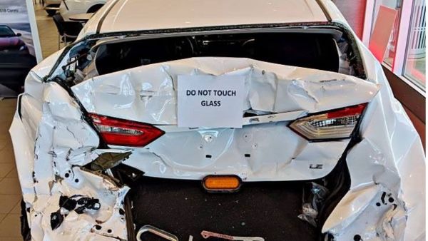 crashed camry displayed in toyota showroom