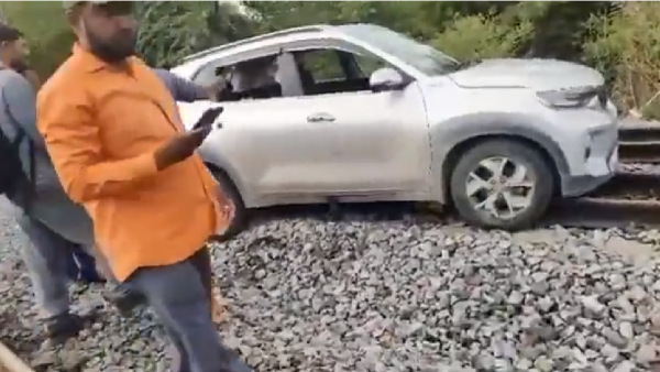 lady driver drove car on railway track