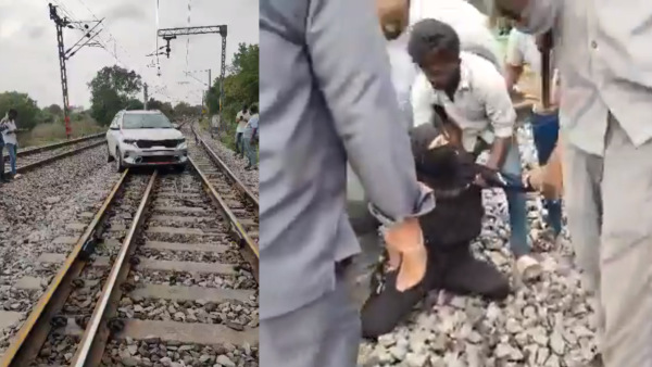 lady driver drove car on railway track