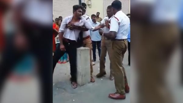 ஹெல்மெட் அணியாமல் வந்த இளைஞரை பிடித்து ரவுண்டு கட்டி அடித்த போலீசார்!