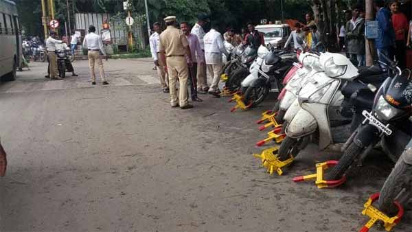 போலீஸின் தடையைமீறி ஸ்கூட்டரை எடுத்துசெல்ல முயன்ற இரு பெண்கள்... வைரல் புகைப்படம்...!