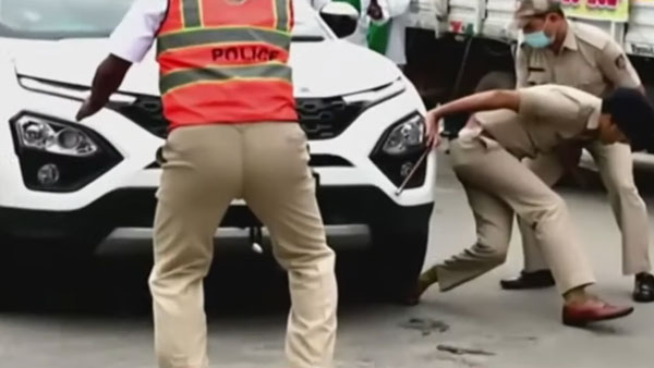 துணை போலீஸ் கமிஷ்னரின் காலின் மீது காரை ஏற்றிய போராட்டக்காரர்!! சிறிதுநேரத்தில் பரபரப்பாகிய முக்கிய சாலை