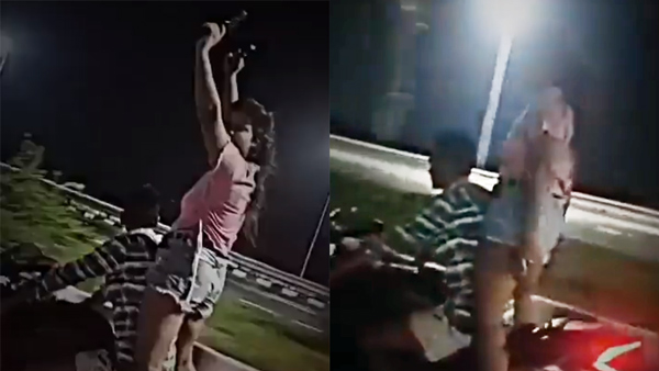 Boy, Girl Bike Stunt With Pistols