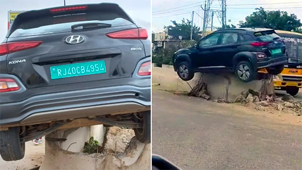 car stuck on road divider