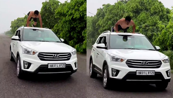 Man Doing Push-ups On Top Of A Hyundai Creta