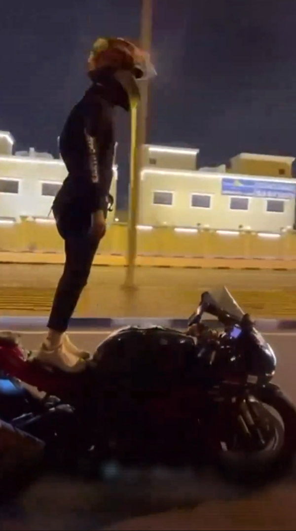 Motorcyclist performing dangerous stunts