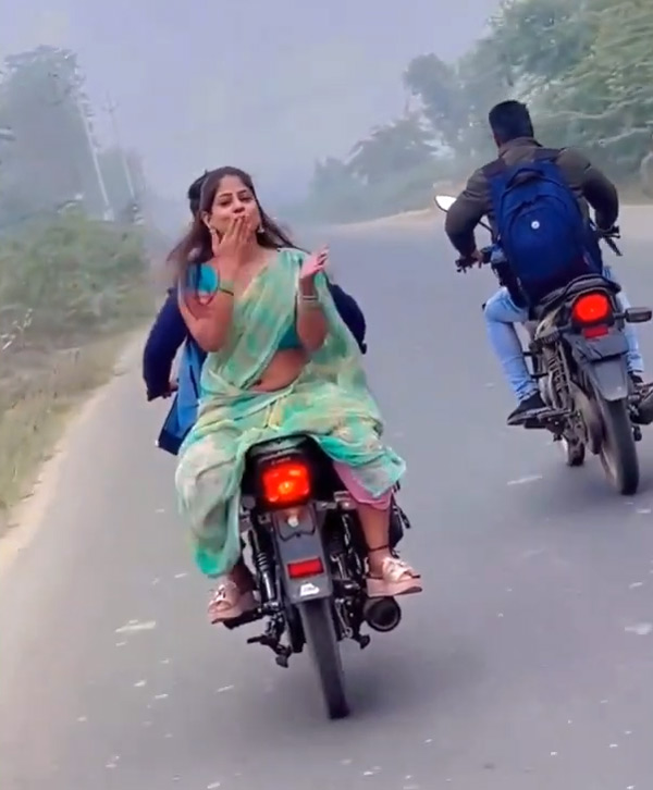 Moving bike women flying kiss