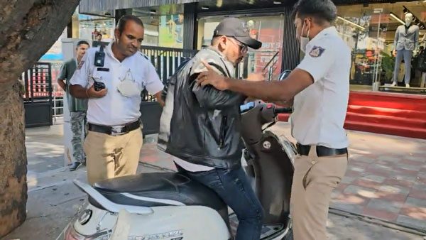 scooter rider bites traffic policeman