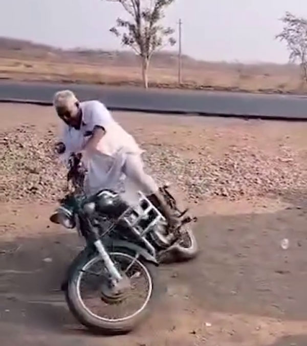 Old man doing donuts on a royal enfield