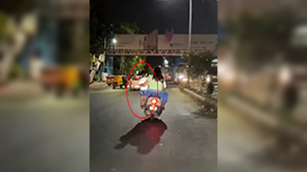 child standing on scooter footrest