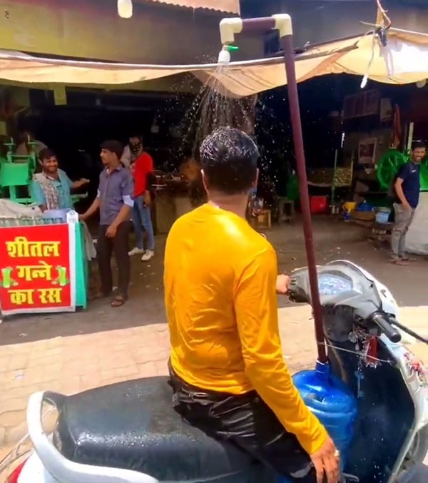 man installing shower on scooter