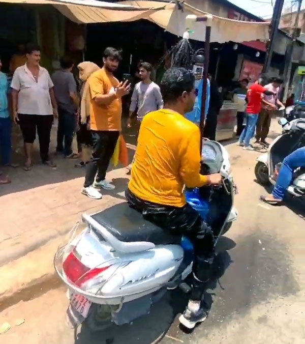 man installing shower on scooter