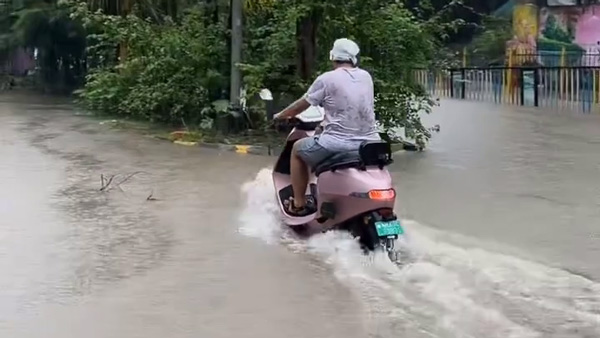 scooter rider rides through Floods