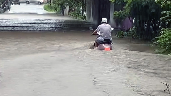 scooter rider rides through Floods