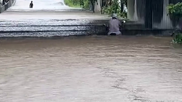 scooter rider rides through Floods
