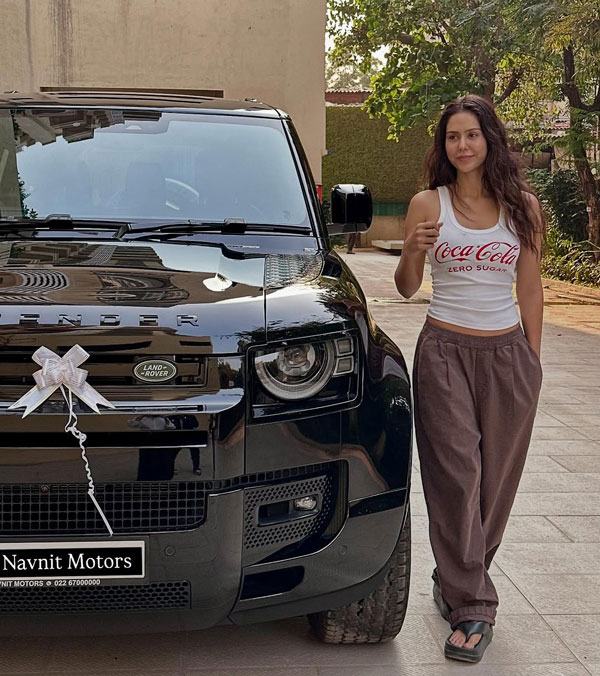 Actress sonam bajwa stands with land rover defender