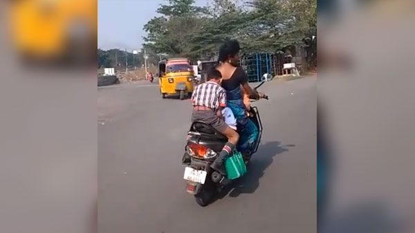 కదిలే స్కూటర్ మీద హోమ్ వర్క్ చేస్తున్న పిల్లాడు కదిలే స్కూటర్ మీద హోమ్ వర్క్ చేస్తున్న పిల్లాడు