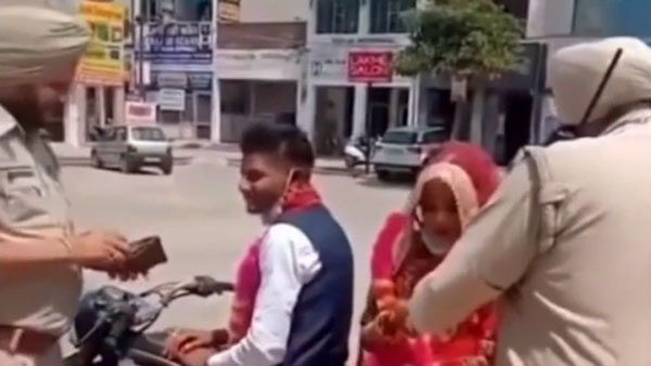 లాక్‌డౌన్ లో రోడ్డుపై కనిపించిన కొత్త జంట మెడలో పూల మాలలు వేసిన పోలీసులు[వీడియో]