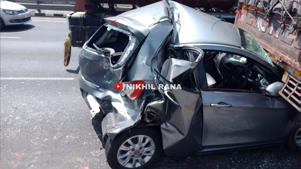 tata tiago car heavily damaged after crashed by two trucks 