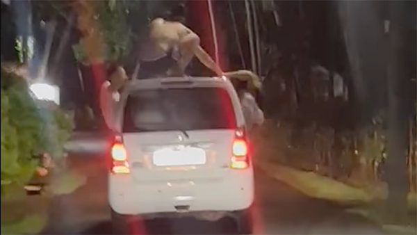 tourists dangerous stunts on moving car in goa