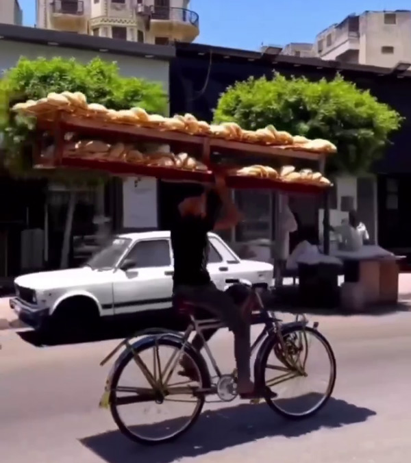 Man-Rides-Cycle-With-Bread-Rack