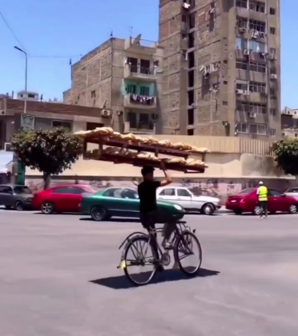 Man-Rides-Cycle-With-Bread-Rack