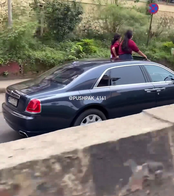 school girls hanging out of rolls royce sunroof