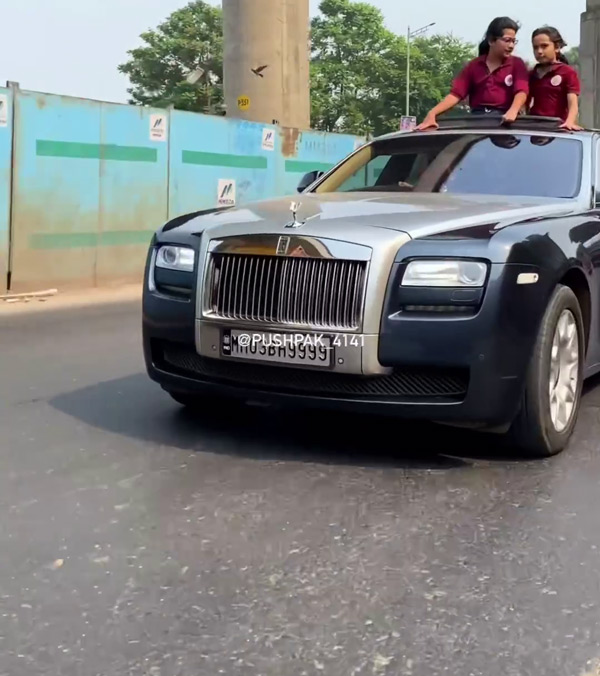 girls standing at sunroof in rolls royce car