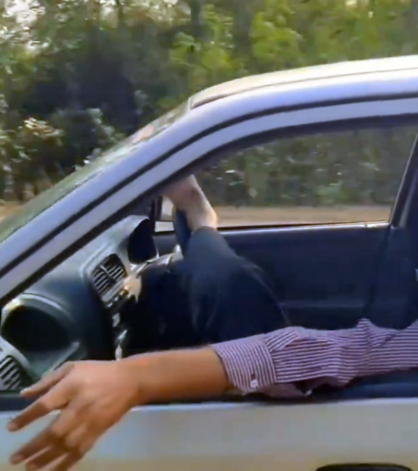 Man drives car with feet Man drives car with feet