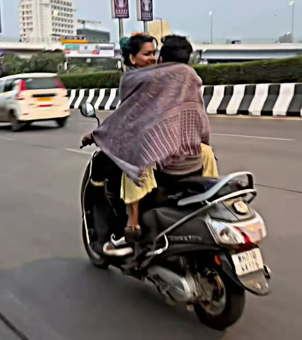 couple-seen-romancing-on-moving-scooter